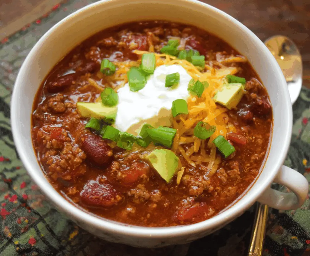 Delicious Crockpot chili with ground beef, beans, tomatoes, and spices served in a bowl for a hearty meal