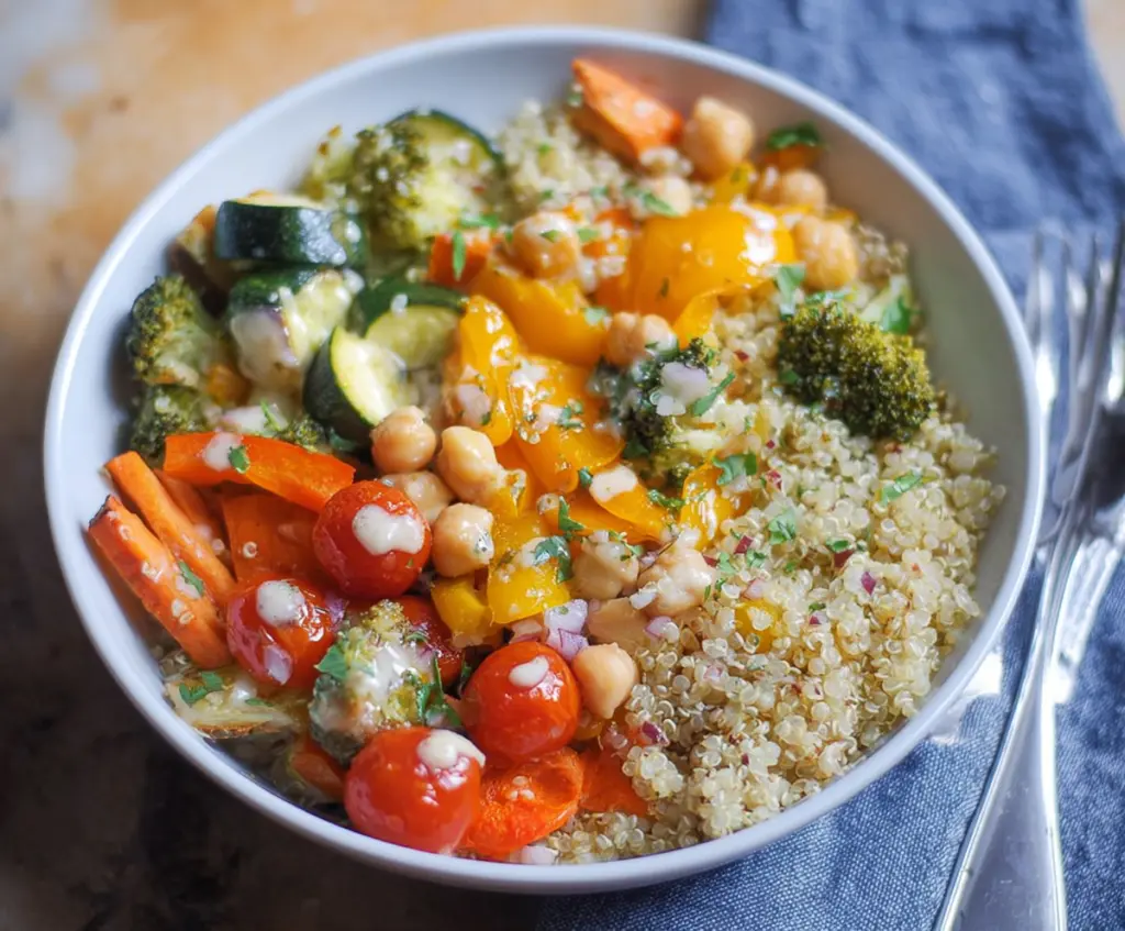 Colorful clean eating quinoa veggie bowl with fresh vegetables and herbs, healthy meal idea