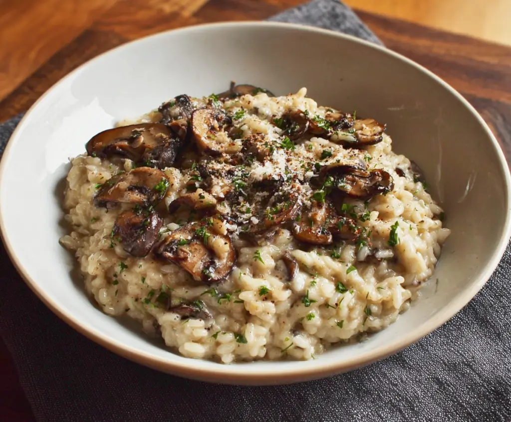 Creamy mushroom risotto served in a bowl, perfect for a romantic dinner for two.