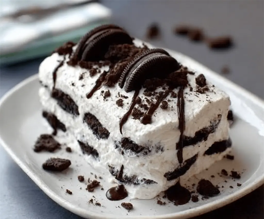 Delicious No Bake Oreo Icebox Cake layered with creamy filling and crunchy Oreo cookies.